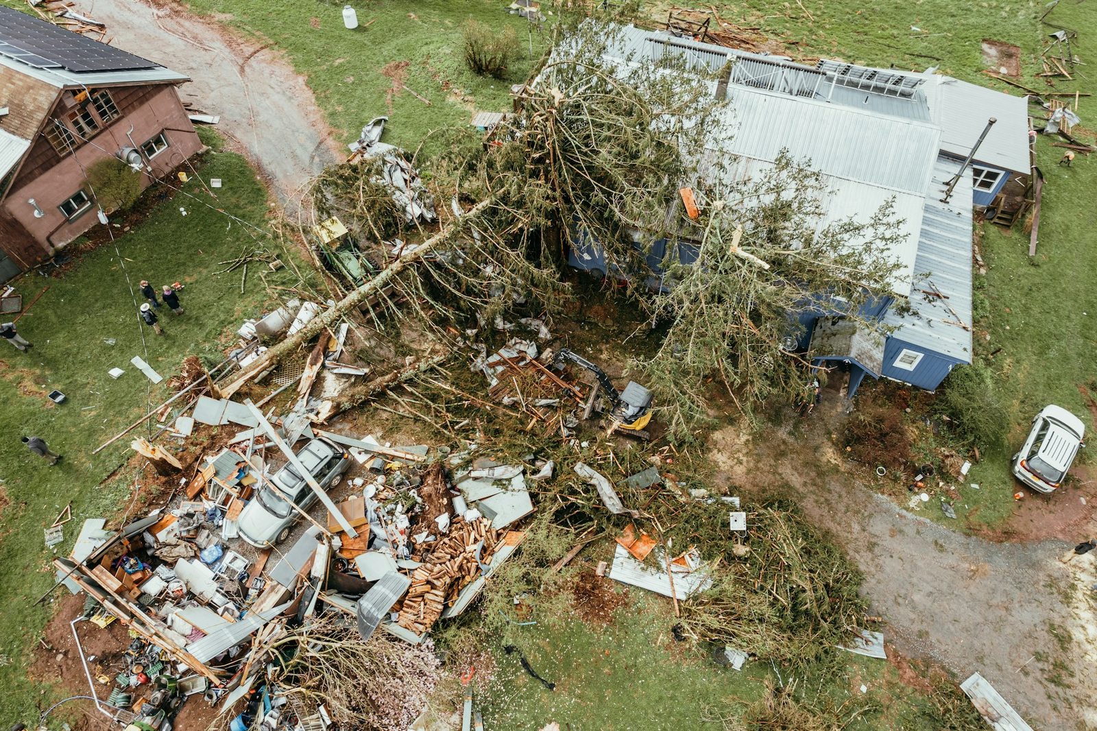 Restoration crew assessing exterior damage on a Northwest Florida home